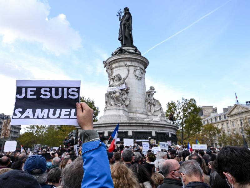 Demonstrators like the one shown here carried "I am Samuel" signs as they gathered on Place de la République in Paris on Sunday to pay tribute to slain history teacher Samuel Paty. Similar gatherings took place in several other cities as France reels fro Demonstrators like the one shown here carried "I am Samuel" signs as they gathered on Place de la République in Paris on Sunday to pay tribute to slain history teacher Samuel Paty. Similar gatherings took place in several other cities as France reels fro