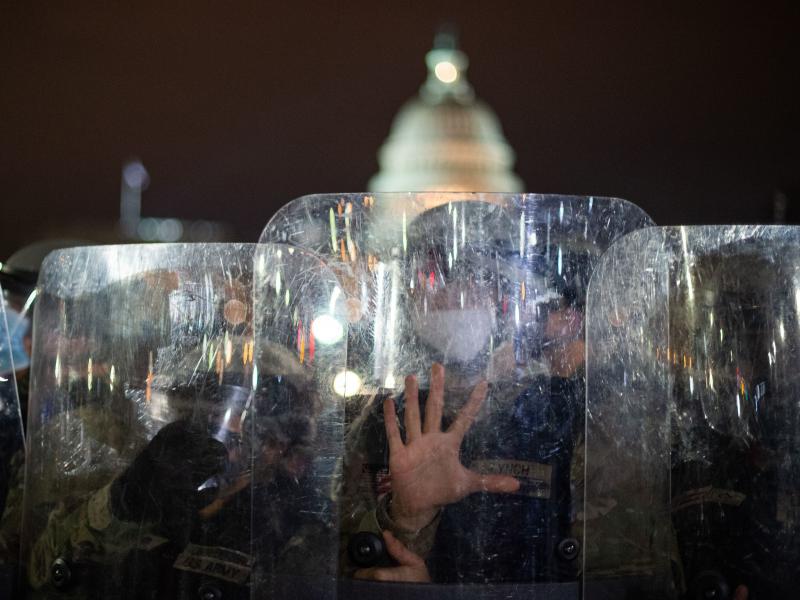 National Guard troops stand behind shields outside the Capitol building in Washington, D.C., on Wednesday evening. National Guard troops stand behind shields outside the Capitol building in Washington, D.C., on Wednesday evening.