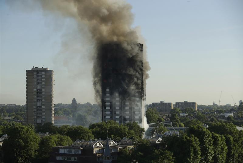 Smoke rises from the Grenfell Tower in west London on Wednesday. A massive fire raced through the 24-story high-rise apartment building overnight. Smoke rises from the Grenfell Tower in west London on Wednesday. A massive fire raced through the 24-story high-rise apartment building overnight.