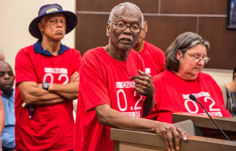 Robert Taylor, center, speaks at a St. John the Baptist Parish council meeting in 2017. He and the other members of the citizens' group around him wear T-shirts that reference the safety limit for the chemical chloroprene. Robert Taylor, center, speaks at a St. John the Baptist Parish council meeting in 2017. He and the other members of the citizens' group around him wear T-shirts that reference the safety limit for the chemical chloroprene.