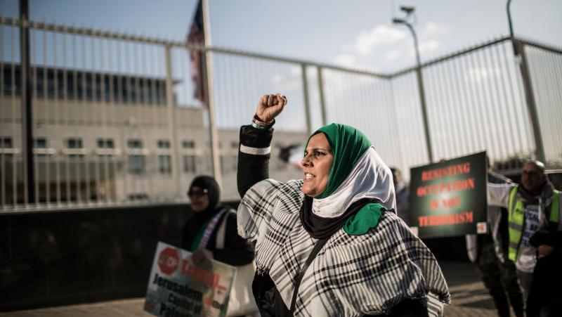 A pro-Palestinian protester raises her fist at a rally outside the U.S. Consulate General in Johannesburg on Tuesday. The South African demonstrators were just some of those who took to city streets to protest the killing of dozens of people along the Gaz A pro-Palestinian protester raises her fist at a rally outside the U.S. Consulate General in Johannesburg on Tuesday. The South African demonstrators were just some of those who took to city streets to protest the killing of dozens of people along the Gaz