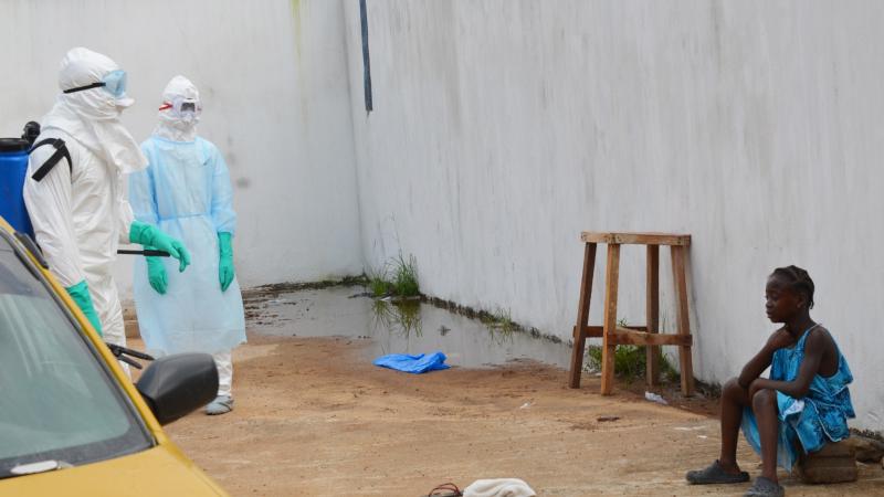 A girl cries outside an Ebola treatment center in Monrovia in late September. Both her parents died in the Ebola outbreak. A girl cries outside an Ebola treatment center in Monrovia in late September. Both her parents died in the Ebola outbreak.