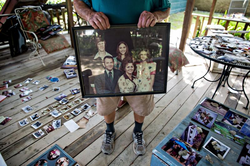 Hilton Pray, 82, holds one of thousands of his photographs that were damaged after an estimated 4-feet of water filled his home in Denham Springs, La. Hilton Pray, 82, holds one of thousands of his photographs that were damaged after an estimated 4-feet of water filled his home in Denham Springs, La.
