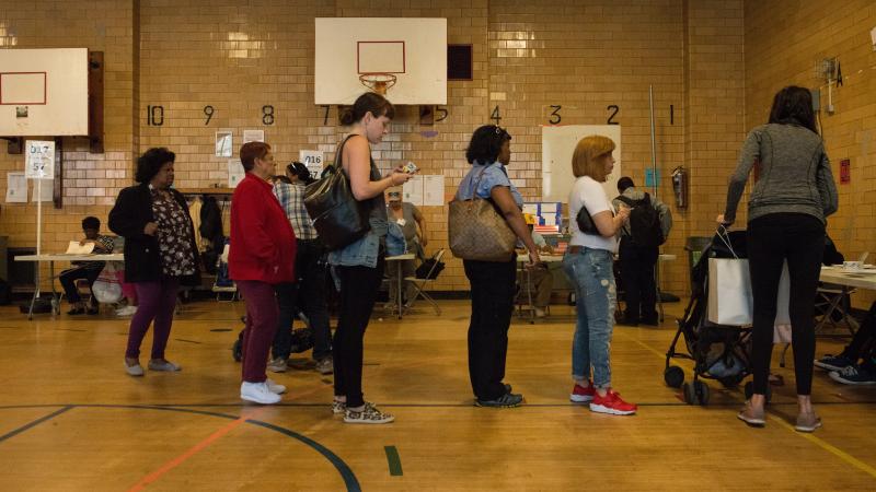 People line up to check in to their voting station at Public School 22 in Brooklyn on Tuesday. People line up to check in to their voting station at Public School 22 in Brooklyn on Tuesday.