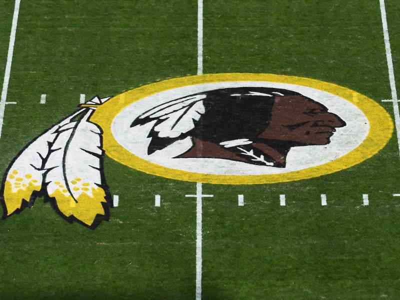 The Washington Redskins' logo is seen before a game in 2019 in Landover, Md. The Redskins have announced the team will be dropping its moniker, which is widely considered a slur against Native Americans. The Washington Redskins' logo is seen before a game in 2019 in Landover, Md. The Redskins have announced the team will be dropping its moniker, which is widely considered a slur against Native Americans.
