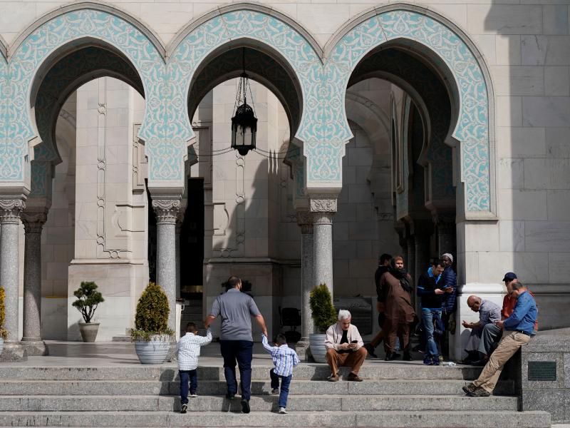 A man leads two young boys into Friday prayers as Muslim worshippers arrive for prayer following the mosque attacks in New Zealand at the Islamic Center of Washington in Washington. A man leads two young boys into Friday prayers as Muslim worshippers arrive for prayer following the mosque attacks in New Zealand at the Islamic Center of Washington in Washington.