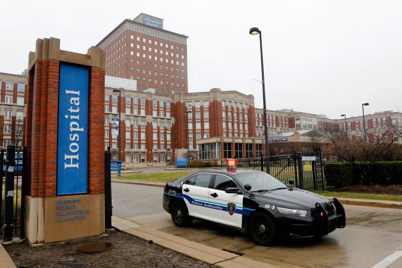 More than 2,600 health care workers in the Detroit area either have been out sick with symptoms similar to those of COVID-19 or have tested positive for the coronavirus. Above, a police car leaves Henry Ford Hospital in Detroit on April 7. More than 2,600 health care workers in the Detroit area either have been out sick with symptoms similar to those of COVID-19 or have tested positive for the coronavirus. Above, a police car leaves Henry Ford Hospital in Detroit on April 7.