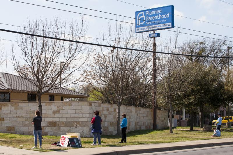 Anti-abortion-rights activists pray outside a Planned Parenthood clinic that offers abortions in 2016 in Austin. Texas has suspended most abortions during the coronavirus pandemic. Anti-abortion-rights activists pray outside a Planned Parenthood clinic that offers abortions in 2016 in Austin. Texas has suspended most abortions during the coronavirus pandemic.