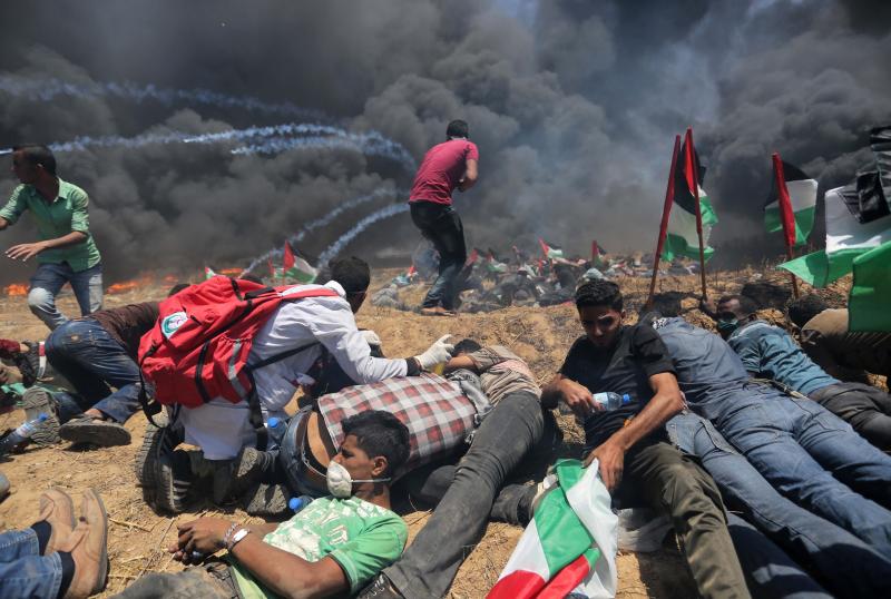 Palestinians set tires on fire, as Israeli soldiers attempt to prevent protesters from breaking through the Gaza-Israel border. The demonstration marked the 70th anniversary of Nakba, or catastrophe, a commemoration of the displacement of hundreds of thou Palestinians set tires on fire, as Israeli soldiers attempt to prevent protesters from breaking through the Gaza-Israel border. The demonstration marked the 70th anniversary of Nakba, or catastrophe, a commemoration of the displacement of hundreds of thou