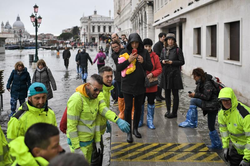 Volunteers set up a footbridge across Venice's flooded Riva degli Schiavoni embankment on Nov. 13. Volunteers set up a footbridge across Venice's flooded Riva degli Schiavoni embankment on Nov. 13.