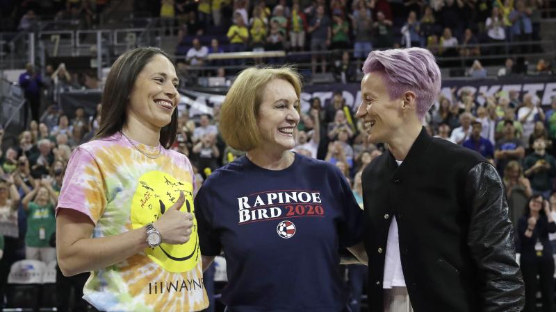 Seattle Mayor Jenny Durkan, center, wears a T-shirt honoring Megan Rapinoe, right, of the U.S. women's World Cup champion soccer team and the Seattle Storm's Sue Bird, left, before a WNBA game on July 12. Seattle Mayor Jenny Durkan, center, wears a T-shirt honoring Megan Rapinoe, right, of the U.S. women's World Cup champion soccer team and the Seattle Storm's Sue Bird, left, before a WNBA game on July 12.