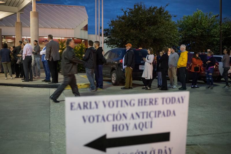 People wait in line to vote at a polling place on the first day of early voting on Oct. 22 in Houston. Texas Attorney General Ken Paxton has been aggressively prosecuting people for voting violations, which critics argue is designed to intimidate non-whit People wait in line to vote at a polling place on the first day of early voting on Oct. 22 in Houston. Texas Attorney General Ken Paxton has been aggressively prosecuting people for voting violations, which critics argue is designed to intimidate non-whit