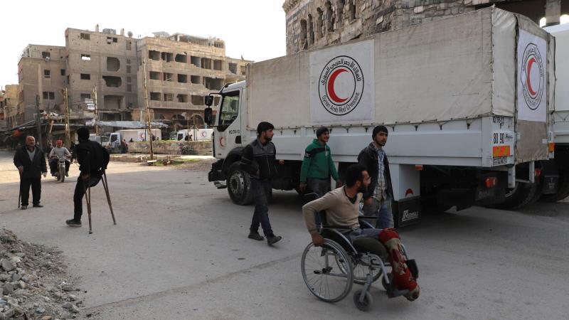 A convoy of Syrian Red Crescent trucks arrives in Douma, in the Syrian rebel-held enclave of Eastern Ghouta, on Monday. This aid convoy is the first to reach the besieged area in weeks. A convoy of Syrian Red Crescent trucks arrives in Douma, in the Syrian rebel-held enclave of Eastern Ghouta, on Monday. This aid convoy is the first to reach the besieged area in weeks.