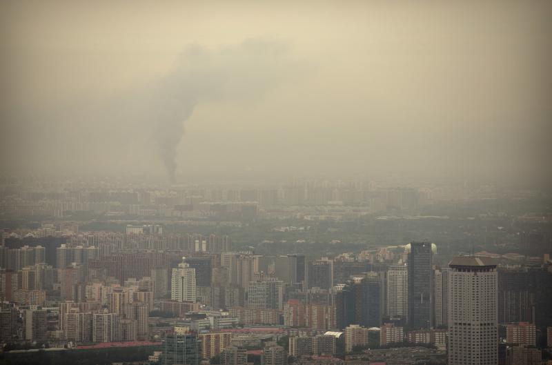 Smoke rises above the skyline of Beijing on a moderately polluted day in 2017. Smoke rises above the skyline of Beijing on a moderately polluted day in 2017.