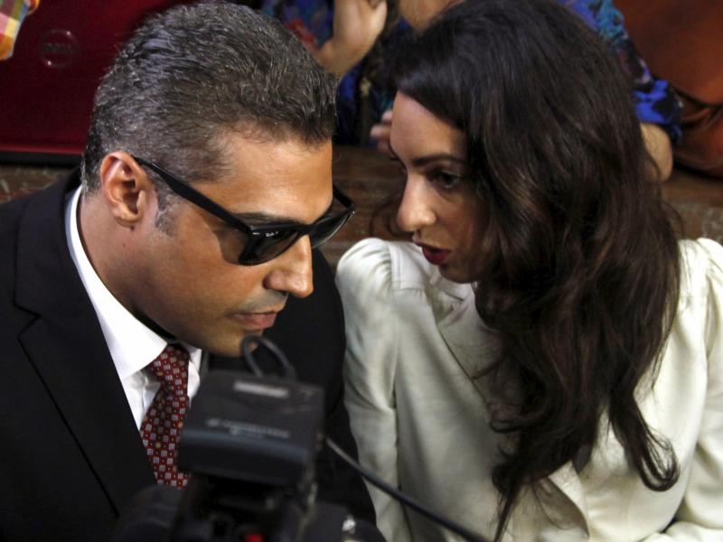 Al-Jazeera English television journalist Mohamed Fahmy talks to his lawyer Amal Clooney before hearing the verdict at a court in Cairo, Egypt, on Saturday. Fahmy and two others were sentenced to three years in prison on terrorism-related charges. Al-Jazeera English television journalist Mohamed Fahmy talks to his lawyer Amal Clooney before hearing the verdict at a court in Cairo, Egypt, on Saturday. Fahmy and two others were sentenced to three years in prison on terrorism-related charges.