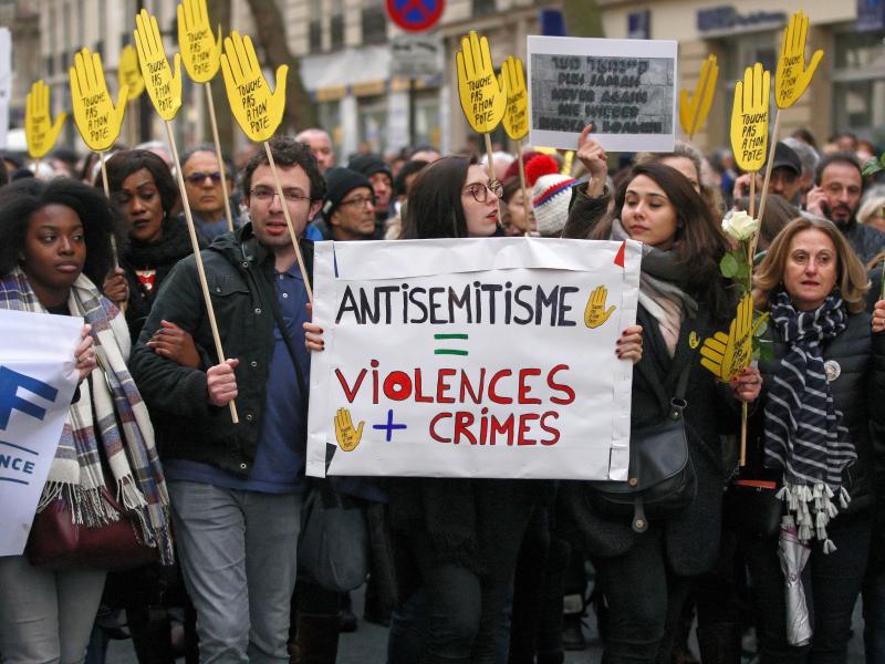 Demonstrators hold signs against anti-Semitism during a silent march in Paris on March 28 in memory of Mireille Knoll, an 85-year-old Jewish woman murdered in her home in what police believe was an anti-Semitic attack. Knoll escaped the mass deportation o Demonstrators hold signs against anti-Semitism during a silent march in Paris on March 28 in memory of Mireille Knoll, an 85-year-old Jewish woman murdered in her home in what police believe was an anti-Semitic attack. Knoll escaped the mass deportation o