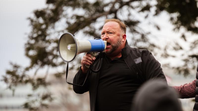 Alex Jones addresses a pro-Trump crowd on Jan. 6, the day of the U.S. Capitol riot. Jones is widely known for his support of baseless and often bigoted conspiracy theories, and he has been banned from many tech platforms, though not Amazon. Alex Jones addresses a pro-Trump crowd on Jan. 6, the day of the U.S. Capitol riot. Jones is widely known for his support of baseless and often bigoted conspiracy theories, and he has been banned from many tech platforms, though not Amazon.