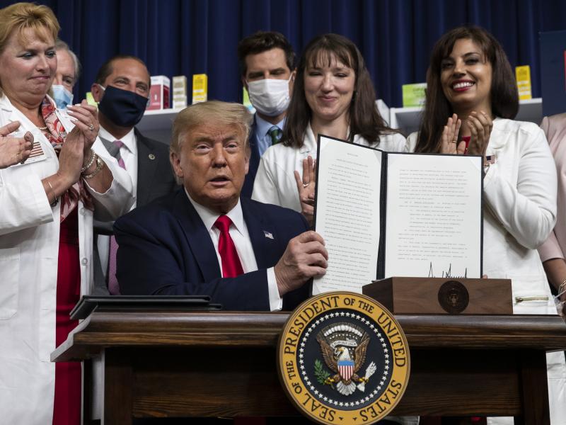 President Trump holds up a signed executive order on lowering drug prices on July 24. President Trump holds up a signed executive order on lowering drug prices on July 24.