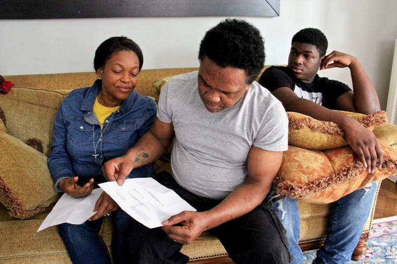 Clive Thompson reads aloud the letter that means he and his wife, Oneita, no longer need to fear deportation. They are joined by their son, Timothy, 15. Clive Thompson reads aloud the letter that means he and his wife, Oneita, no longer need to fear deportation. They are joined by their son, Timothy, 15.