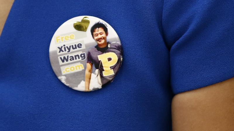 Hua Qu, the wife of Xiyue Wang, a Princeton University graduate student being held at an Iranian prison, wears a button bearing a picture of her husband as she speaks at a news conference to mark the third anniversary of his imprisonment, Aug. 8, 2019, in Hua Qu, the wife of Xiyue Wang, a Princeton University graduate student being held at an Iranian prison, wears a button bearing a picture of her husband as she speaks at a news conference to mark the third anniversary of his imprisonment, Aug. 8, 2019, in