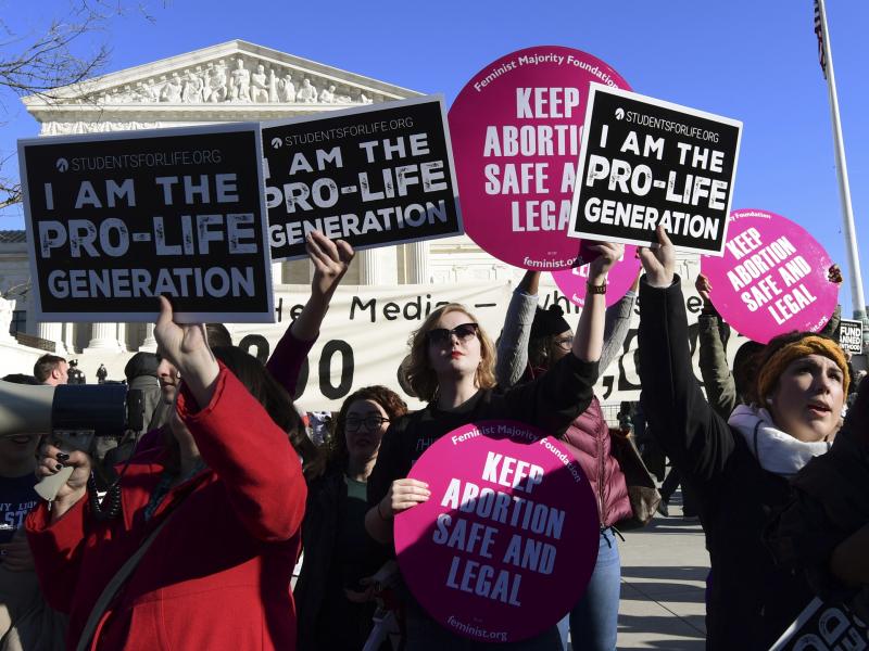 Protesters on both sides of the abortion issue gather outside the Supreme Court in Washington on Jan. 19 during the March for Life. Protesters on both sides of the abortion issue gather outside the Supreme Court in Washington on Jan. 19 during the March for Life.
