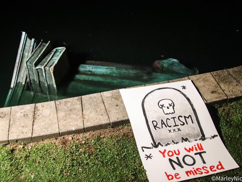 A statue of Christopher Columbus sits in the water after people pulled the memorial down Tuesday night in Richmond, Va. A statue of Christopher Columbus sits in the water after people pulled the memorial down Tuesday night in Richmond, Va.