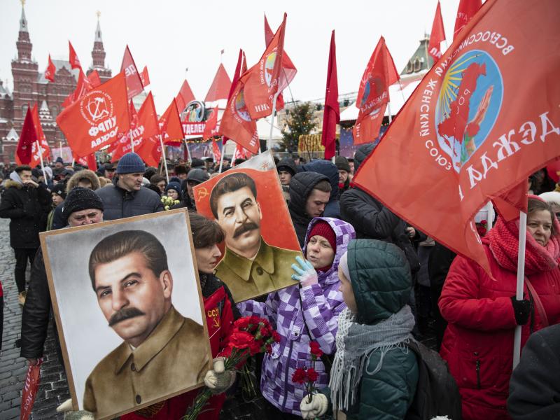 People hold portraits of Soviet leader Josef Stalin in December 2018 as they line up in Moscow to lay flowers at his grave. People hold portraits of Soviet leader Josef Stalin in December 2018 as they line up in Moscow to lay flowers at his grave.