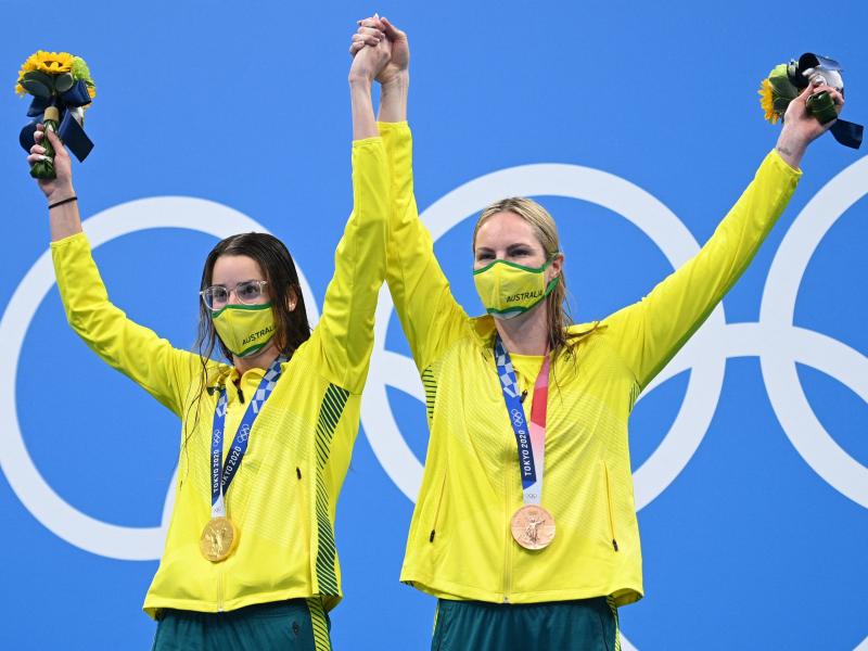 Australian gold medalist Kaylee McKeown (left) poses with bronze medalist and teammate Emily Seebohm, who she invited to the top podium after the women's 200-meter backstroke swimming final at the Tokyo Olympics on Saturday. Australian gold medalist Kaylee McKeown (left) poses with bronze medalist and teammate Emily Seebohm, who she invited to the top podium after the women's 200-meter backstroke swimming final at the Tokyo Olympics on Saturday.