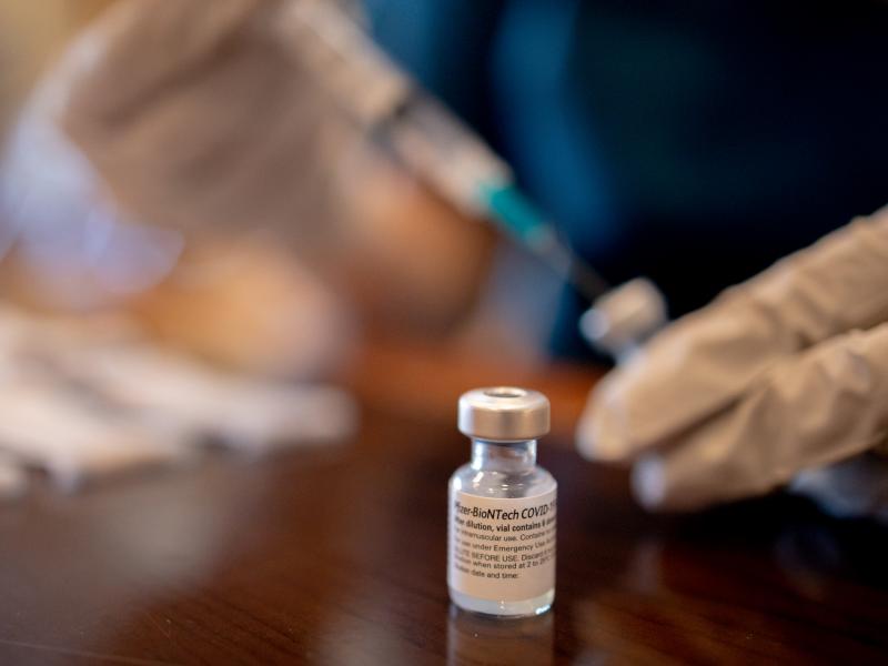 A health care worker prepares third doses of Pfizer-BioNTech COVID-19 vaccines for a senior living facility in Worcester, Pa., in late August. A health care worker prepares third doses of Pfizer-BioNTech COVID-19 vaccines for a senior living facility in Worcester, Pa., in late August.
