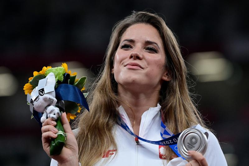 Poland's Maria Magdalena Andrejczyk celebrates her silver medal in the javelin throw at the Olympic Stadium in Tokyo on Aug. 7. She auctioned the medal to help fund heart surgery for an 8-month-old; the buyer decided to let her keep it. Poland's Maria Magdalena Andrejczyk celebrates her silver medal in the javelin throw at the Olympic Stadium in Tokyo on Aug. 7. She auctioned the medal to help fund heart surgery for an 8-month-old; the buyer decided to let her keep it.