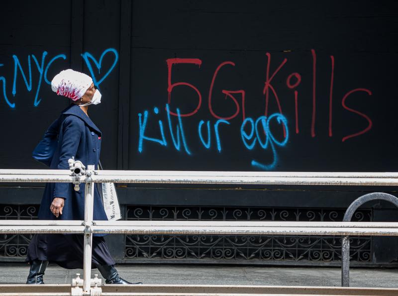 A pedestrian walks past anti-5G graffiti in the Flatiron District of New York in May. A pedestrian walks past anti-5G graffiti in the Flatiron District of New York in May.