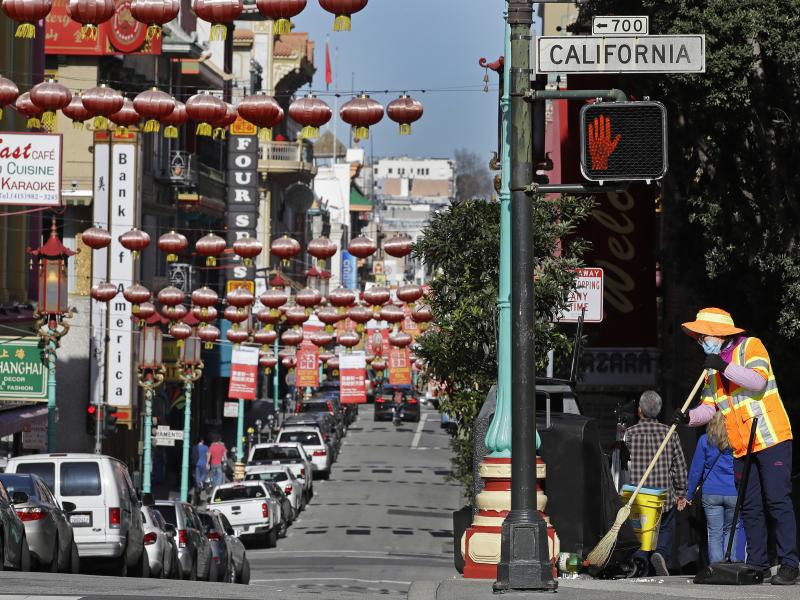 In this Jan. 31, 2020, file photo, a masked worker cleans a street in the Chinatown district in San Francisco. Police and volunteers have increased their street presence after a series of violent attacks against older Asian residents in Bay Area cities st In this Jan. 31, 2020, file photo, a masked worker cleans a street in the Chinatown district in San Francisco. Police and volunteers have increased their street presence after a series of violent attacks against older Asian residents in Bay Area cities st