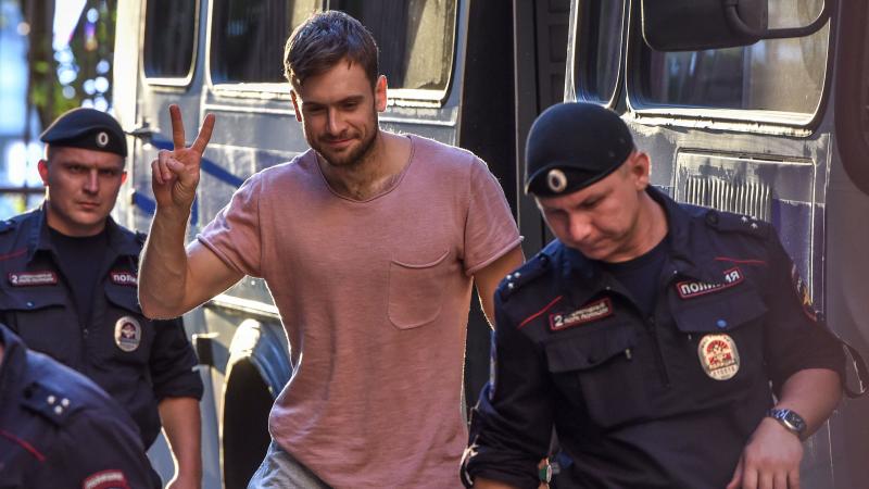 Pyotr Verzilov (center) walks to a court hearing related to Pussy Riot's rushing of the World Cup final pitch on July 15. The group suspects Verzilov was poisoned on Tuesday. Pyotr Verzilov (center) walks to a court hearing related to Pussy Riot's rushing of the World Cup final pitch on July 15. The group suspects Verzilov was poisoned on Tuesday.