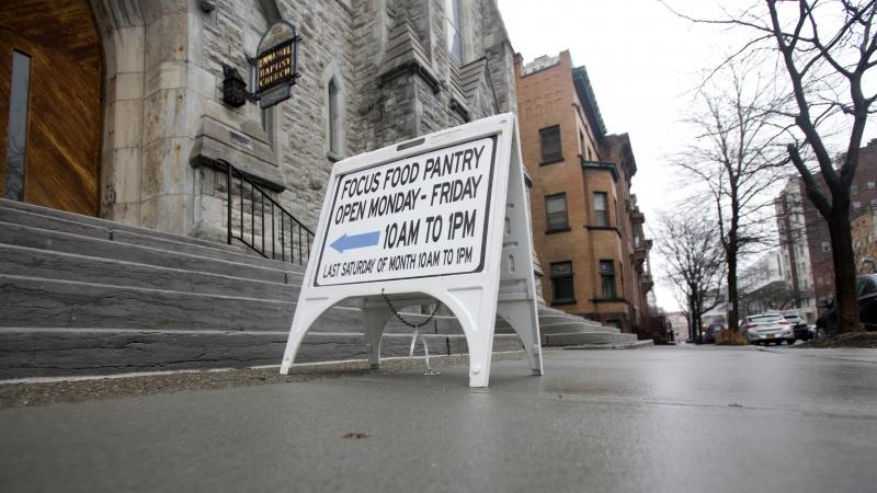 A sign sits on a sidewalk outside the Interfaith Food Pantry at Emmanuel Baptist Church in February in Albany, N.Y. Congress may be under more pressure than usual to cut safety net spending — health care, housing assistance, welfare and food aid — to A sign sits on a sidewalk outside the Interfaith Food Pantry at Emmanuel Baptist Church in February in Albany, N.Y. Congress may be under more pressure than usual to cut safety net spending — health care, housing assistance, welfare and food aid — to