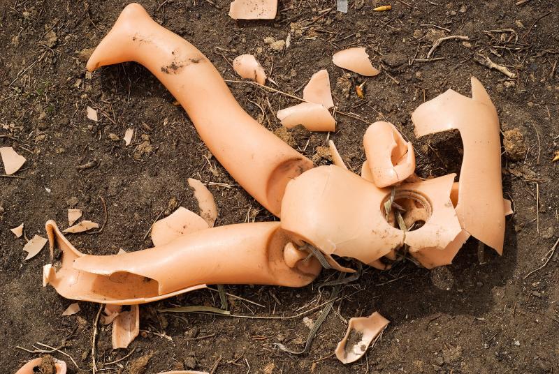 Broken doll on the ground. Broken doll on the ground.