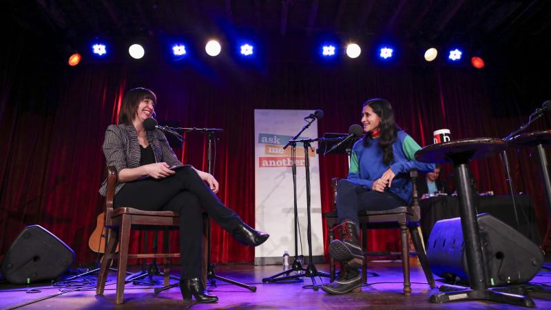 Host Ophira Eisenberg chats with comedian Aparna Nancherla on Ask Me Another at the Bell House in Brooklyn, New York. Host Ophira Eisenberg chats with comedian Aparna Nancherla on Ask Me Another at the Bell House in Brooklyn, New York.