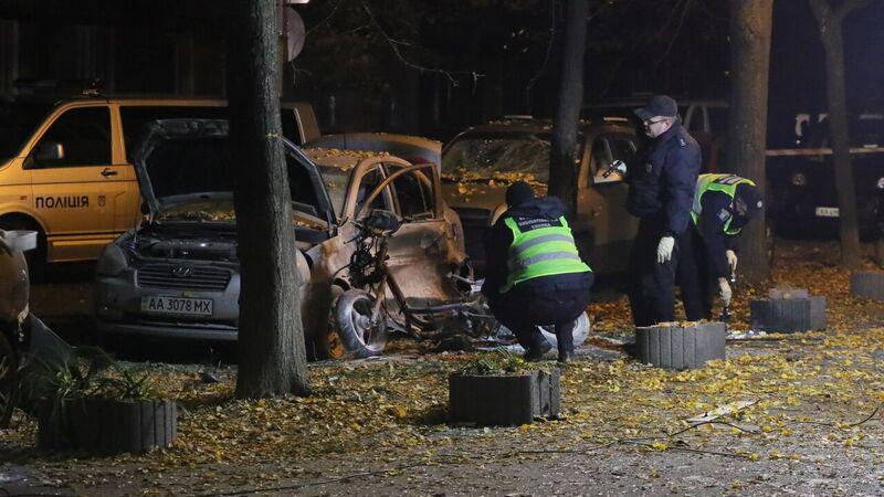 Police officers examine the crime scene where a Ukrainian lawmaker was wounded and his bodyguard killed in Kiev late Wednesday night. Police officers examine the crime scene where a Ukrainian lawmaker was wounded and his bodyguard killed in Kiev late Wednesday night.