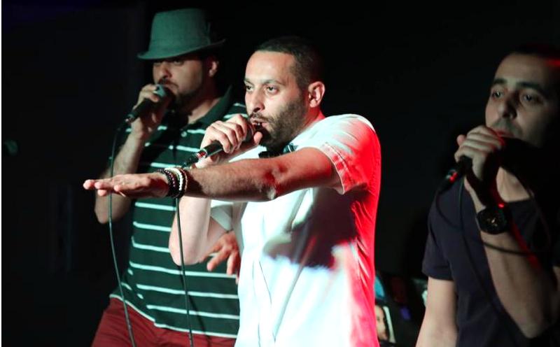 Tamer Nafar (center), performs with the hip-hop group DAM. The members are all Arabs who are citizens of Israel, and some of their lyrics are harshly critical of the state. They see it as artistic freedom, while Israel's culture minister says such languag Tamer Nafar (center), performs with the hip-hop group DAM. The members are all Arabs who are citizens of Israel, and some of their lyrics are harshly critical of the state. They see it as artistic freedom, while Israel's culture minister says such languag