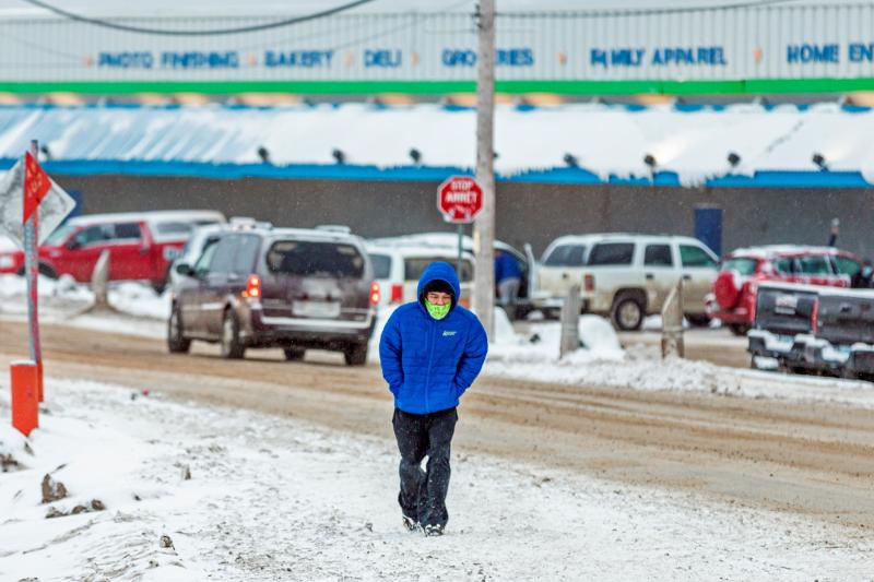 A man wears a mask as the territory of Nunavut enters a two week mandatory restriction period in Iqaluit, Nunavut, Canada, on Wednesday. More than 80 COVID-19 cases have been identified this month in Nunavut, where around 39,000 people, predominantly Inui A man wears a mask as the territory of Nunavut enters a two week mandatory restriction period in Iqaluit, Nunavut, Canada, on Wednesday. More than 80 COVID-19 cases have been identified this month in Nunavut, where around 39,000 people, predominantly Inui
