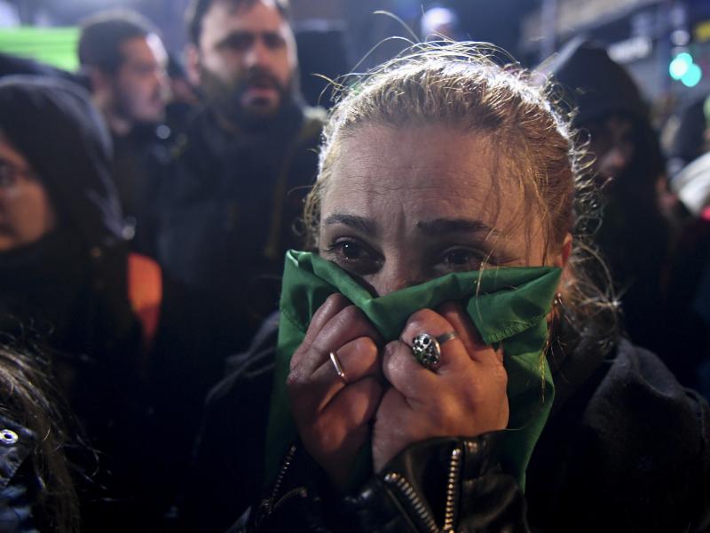 An abortion-rights activist reacts outside the National Congress in Buenos Aires, on Thursday to news that the Senate voted to reject a bill that would have legalized abortion. An abortion-rights activist reacts outside the National Congress in Buenos Aires, on Thursday to news that the Senate voted to reject a bill that would have legalized abortion.