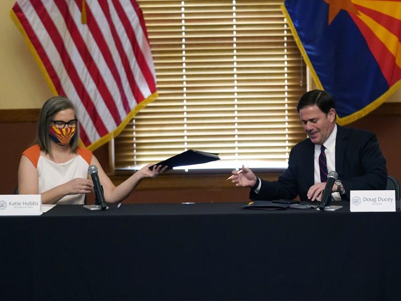 Arizona Secretary of State Katie Hobbs and Gov. Doug Ducey exchange election documents as they certify election results Monday at the Arizona Capitol in Phoenix. Arizona Secretary of State Katie Hobbs and Gov. Doug Ducey exchange election documents as they certify election results Monday at the Arizona Capitol in Phoenix.