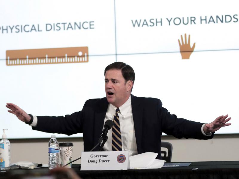 Arizona Gov. Doug Ducey updates reporters on the coronavirus pandemic during a news conference in Phoenix on Monday. Arizona Gov. Doug Ducey updates reporters on the coronavirus pandemic during a news conference in Phoenix on Monday.