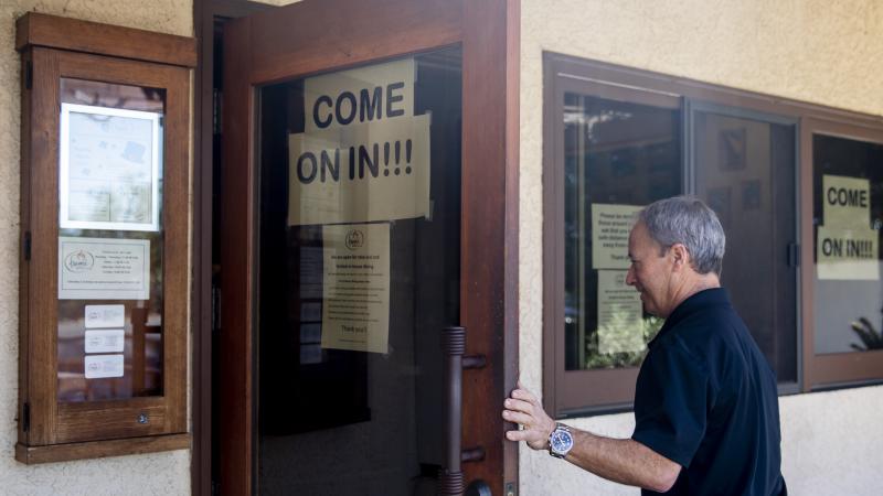 Fume Bistro owner Terry Letson enters his restaurant in Napa, Calif., on Tuesday. A handful of businesses in Napa have made the decision to begin reopening their dining rooms with occupancy limits Fume Bistro owner Terry Letson enters his restaurant in Napa, Calif., on Tuesday. A handful of businesses in Napa have made the decision to begin reopening their dining rooms with occupancy limits