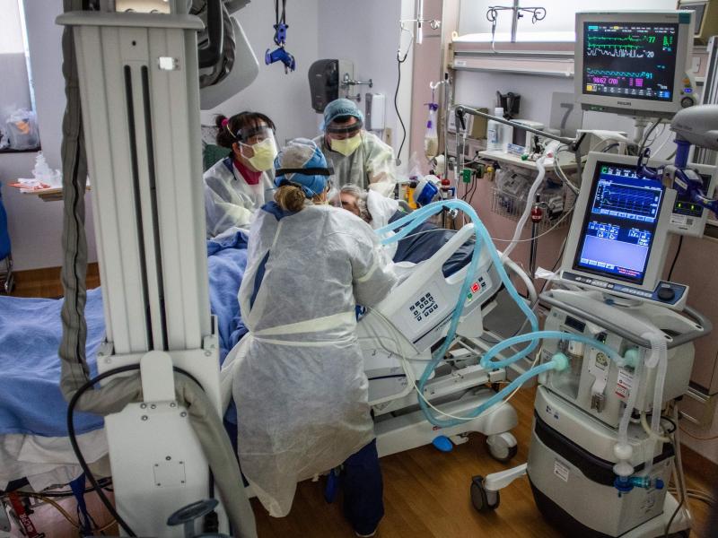 Physicians and nurses wear personal protective equipment while they attend to a COVID-19 patient in the ICU at Providence Cedars-Sinai Tarzana Medical Center in Tarzana, Calif. on December 18, 2020. Physicians and nurses wear personal protective equipment while they attend to a COVID-19 patient in the ICU at Providence Cedars-Sinai Tarzana Medical Center in Tarzana, Calif. on December 18, 2020.
