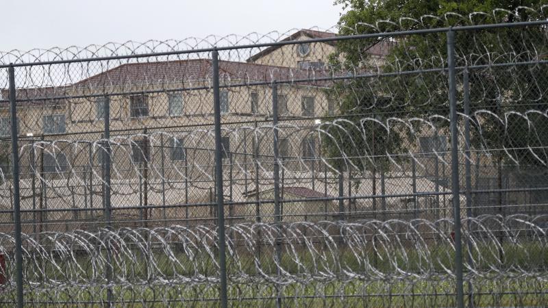 Tents are visible behind wire fences last month near buildings of the Federal Medical Center prison in Fort Worth, Texas. Hundreds of inmates inside the facility reportedly have tested positive for the coronavirus, and several have died. Tents are visible behind wire fences last month near buildings of the Federal Medical Center prison in Fort Worth, Texas. Hundreds of inmates inside the facility reportedly have tested positive for the coronavirus, and several have died.