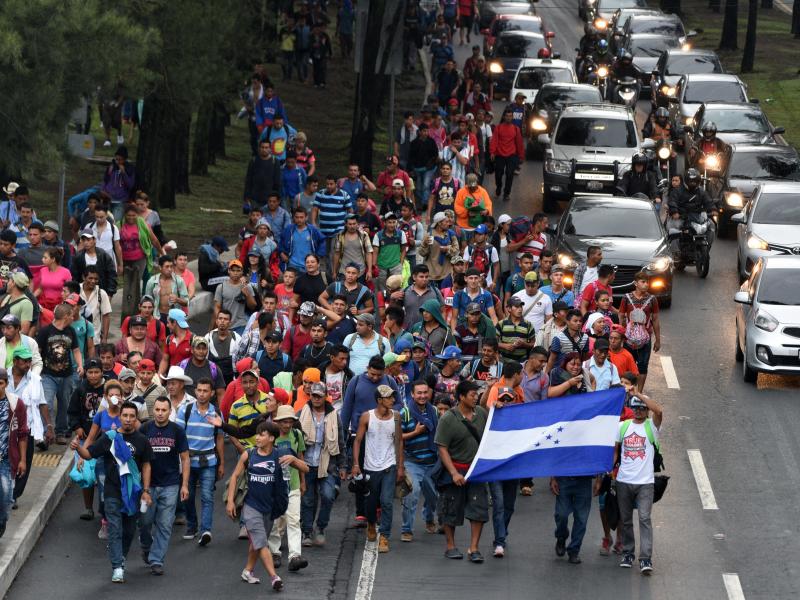 Honduran migrants walk toward Tecún Umán, a Guatemalan town along the Mexican border, as they leave Guatemala City on Thursday. Honduran migrants walk toward Tecún Umán, a Guatemalan town along the Mexican border, as they leave Guatemala City on Thursday.