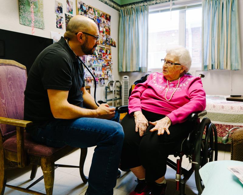 Glenn Hurst gives Jeannette Massen a checkup at the Northcrest Living Center in Council Bluffs, Iowa. As they prepare to caucus, voters weigh which candidate to support and what health care should look like in the future. Glenn Hurst gives Jeannette Massen a checkup at the Northcrest Living Center in Council Bluffs, Iowa. As they prepare to caucus, voters weigh which candidate to support and what health care should look like in the future.