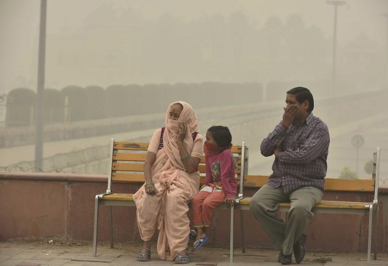 People cover their faces with masks to avoid thick smog in New Delhi on Nov. 5. People living there have complained about respiratory problems. People cover their faces with masks to avoid thick smog in New Delhi on Nov. 5. People living there have complained about respiratory problems.