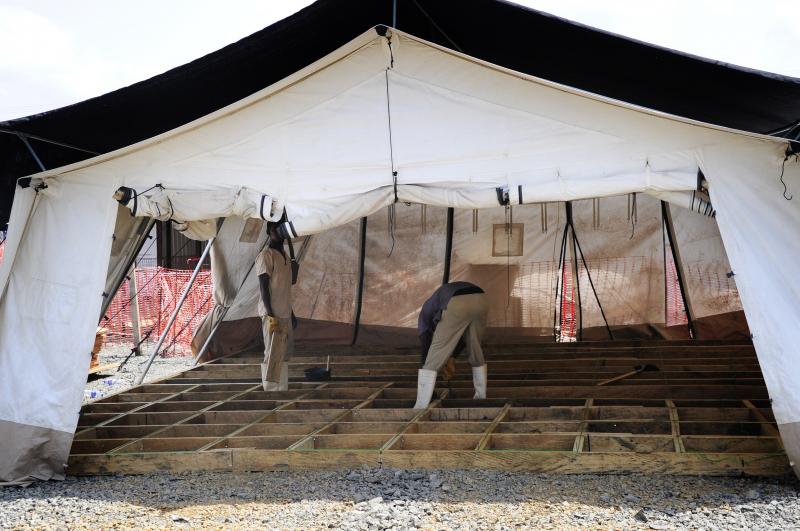 Liberian workers dismantle shelters in an Ebola treatment center in the Paynes Ville neighborhood of Monrovia. Doctors Without Borders closed the center last month because it was no longer needed. Liberian workers dismantle shelters in an Ebola treatment center in the Paynes Ville neighborhood of Monrovia. Doctors Without Borders closed the center last month because it was no longer needed.