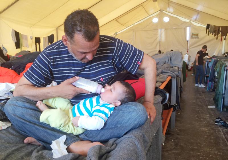 Moyaad Saad, a 43-year-old former civil servant from Baghdad, feeds his 6-month-old daughter Zahara on their cot in a giant tent at a makeshift migrant camp near the border between Greece and Macedonia. Thousands of asylum seekers are now stuck here after Moyaad Saad, a 43-year-old former civil servant from Baghdad, feeds his 6-month-old daughter Zahara on their cot in a giant tent at a makeshift migrant camp near the border between Greece and Macedonia. Thousands of asylum seekers are now stuck here after